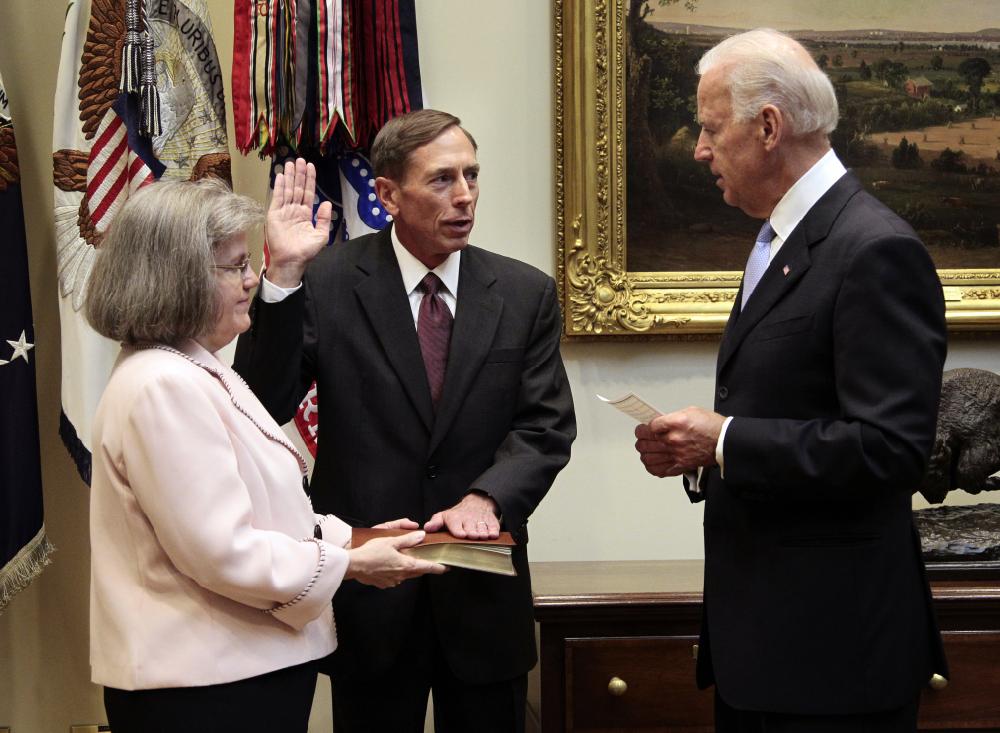Vice President Joe Biden, right, administers the oath of office to Dir. of the CIA David Petraeus, center, during a swearing-in ceremony in the Roosevelt Room of the White House in Washington, Tuesday, Sept., 6, 2011. Holding a Bible is Petraeus' wife Holly Knowlton Petraeus, left. (AP Photo/Pablo Martinez Monsivais)