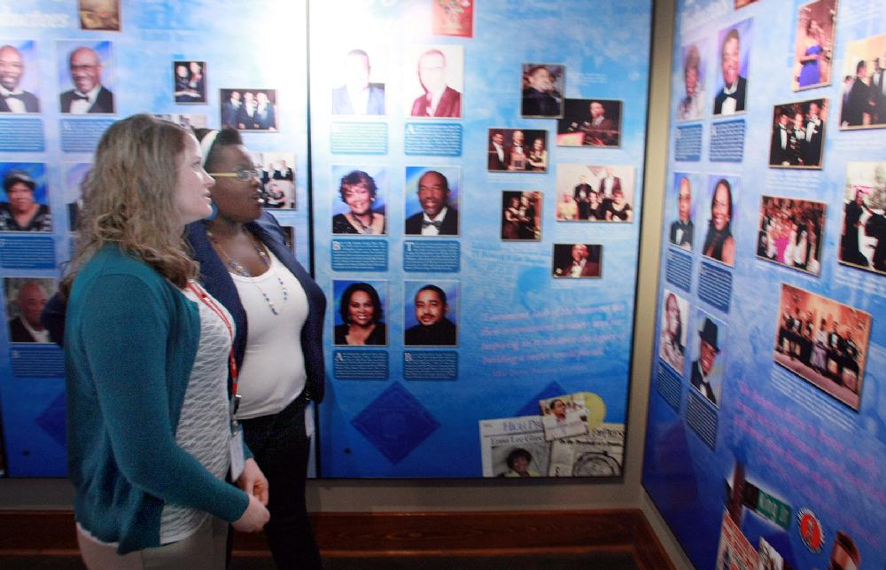 Arkansas Democrat-Gazette/RICK MCFARLAND--09/06/11-- Rachel Acosta (left) and Pamela Watson read the bios and look at the pictures of current inductees of the Arkansas Black Hall of Fame at the Mosaic Templars Cultural Center in Little Rock Tuesday. They were attending an event for the announcement of the 2011 inductees. They are Derek Fisher, Joseph "Joe" Jackson, Abraham Carpenter, Sr. and family, Dr. Robert L. Williams, Kathryn Hall-Trujillo, and Leo "Jocko" Louis Carter. The induction ceremony will be October 15.
