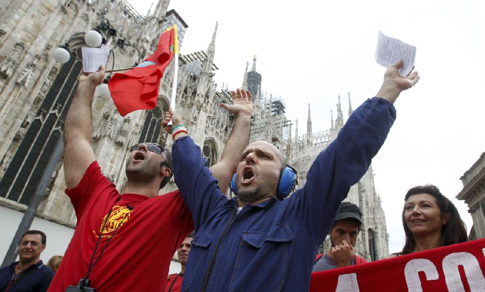People march through downtown Milan, Italy, during a general strike Tuesday, Sept. 6, 2011. A strike by Italy's largest labor union against austerity measures has shut down air, land and sea transport and curtailed other public services throughout the country. Workers for the state railway, city transit systems and ferry services all were on strike. Hospital workers, postal employees and bank tellers also joined in. (AP Photo/Luca Bruno)