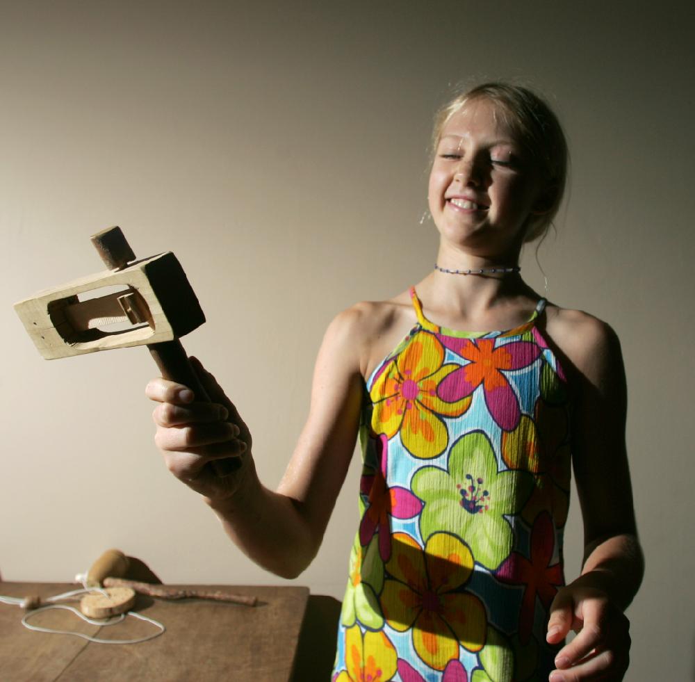 Arkansas Democrat-Gazette/RYAN MCGEENEY --08-04-2011-- 
A selection of old-fashioned toys are now on display at the Shiloh Museum of Ozark History in Springdale. The toys are kept in the open, and patrons are free to play with them. Here, Alex Joyce, 10, of Bella Vista, demonstrates a "rattletrap" toy.