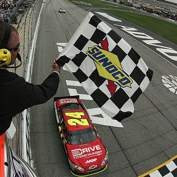 Jeff Gordon takes the checkered flag at the rain-delayed AdvoCare 500 on Tuesday at Atlanta Motor Speedway. The race was originally scheduled for Sunday.