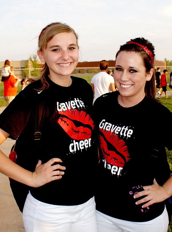 Lion Pride Night — Gravette Lion Cheerleaders Dallas Banta and Makalyn Hurtt show how proud they are to be Lion boosters. The recent Pride Night at Gravette High School drew a huge crowd of Lion supporters. There were scrimmages, good food, band music, introduction of players and, as this photo shows, relaxation and fun for all.