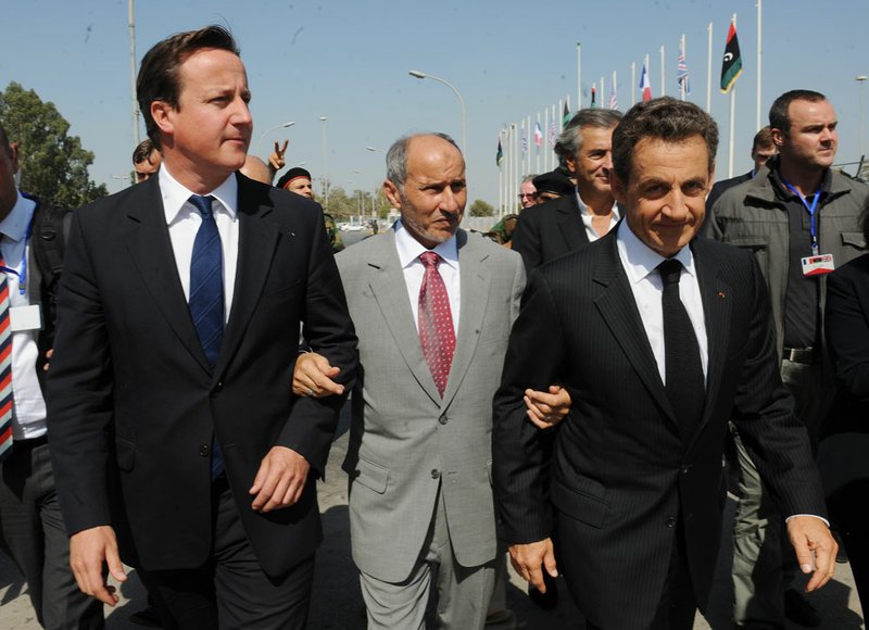 British Prime Minister David Cameron, left, and French President Nicholas Sarkozy, front right, are accompanied by NTC chief Mustafa Abdul-Jalil ahead of a visit to the Tripoli Medical Centre in Tripoli, Thursday, Sept. 15, 2011. 