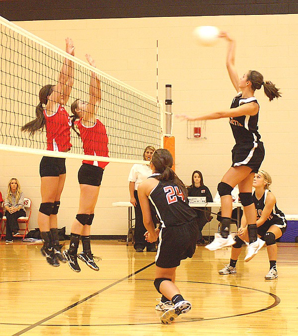 Gravette's Monica White goes up for the kill in Thursday's game against Farmington. The two teams played a close match, with the victor decided in game four.