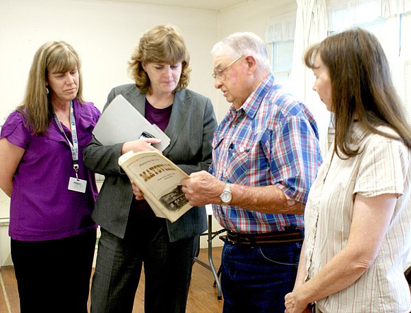 Diane Tindale, second from left, discusses the Maysville P.O. closing with former Maysville Postmaster Marvin Wilber, while postmaster Kim Smith, left, and Martha Tucker look on.