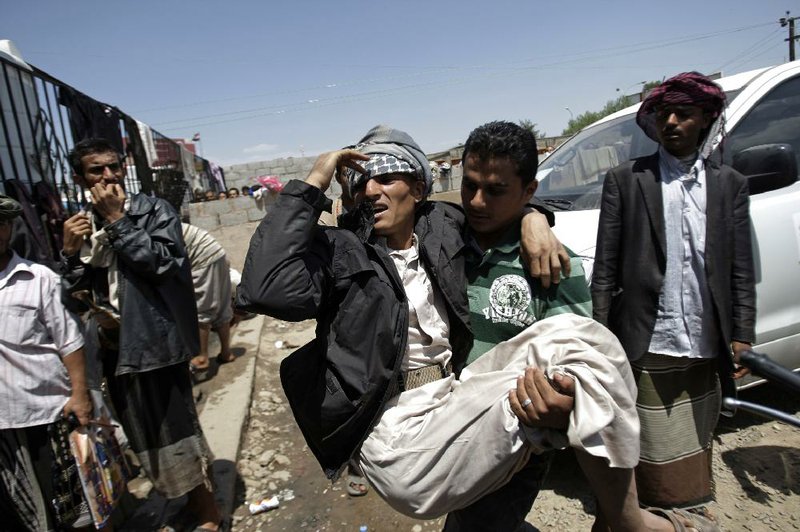 Anti-government protestors carry a wounded man from the site of clashes with security forces, in Sanaa, Yemen, Thursday, Sept. 22, 2011. Renewed violence in the Yemeni capital killed several people on Thursday as street battles broke out between forces loyal to the regime and its opponents, medical and security officials said. (AP Photo/Hani Mohammed)