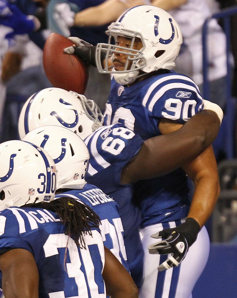  Indianapolis Colts defensive end Jamaal Anderson (90) reacts with defensive tackle Eric Foster (68) after Anderson ran back a fumble by Pittsburgh Steelers quarterback Ben Roethlisberger 47-yards for a touchdown during the second quarter of an NFL football game in Indianapolis, Sunday, Sept. 25, 2011. 