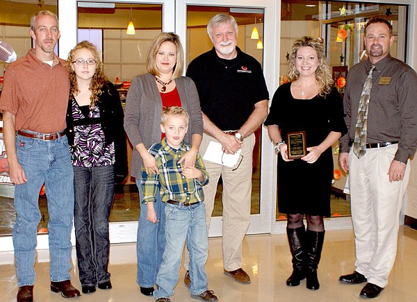 Pictured, in the center, are Beth Johnson and her son Zane. On her right are father Jared Johnson and big sister Victoria, Keith Vire, the honoree Ashley Casey, and elementary principal Zane Vanderpool.
