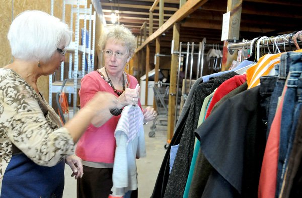 Mary Primm, left, and Norma Curl sort through clothes in the Compassion Center stock room on Thursday. The center will be run largely by volunteers.
