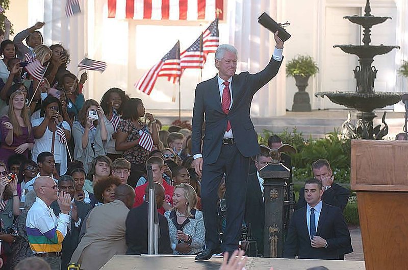 Former President Bill Clinton waves to the crowd at the end of his speech Saturday celebrating the 20th anniversary of his announcement to run for President.
