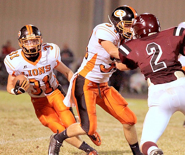 Gravette senior Tyler Greenhaw runs the ball downfield while his teammate Dallas Kerley blocks Gentry defender Nelson Watson during play on Friday.