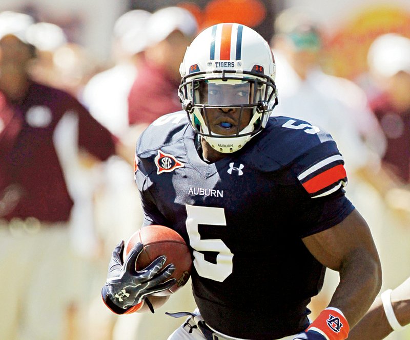 Little Rock native Michael Dyer now plays for Auburn, and his uncle Andre wears Auburn gear in support of his nephew when he works out in a local gym.