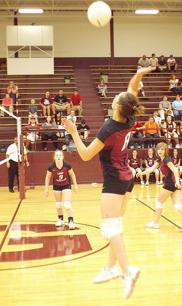 Gentry sophomore Jordan Olds attacks the ball in play against Pea Ridge on Thursday. Emilia Barrick and Josie Graves are in the background.