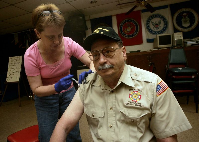 Johnny Gothard of Fort Smith gets a flu shot from Registered Nurse Carol Marvin during a VA Community Based Outpatient Clinic Saturday, September 8, 2011 at the VFW Post 8845 in Fort Smith.  Many veterans are in an at risk group, which includes people over 50 years old.