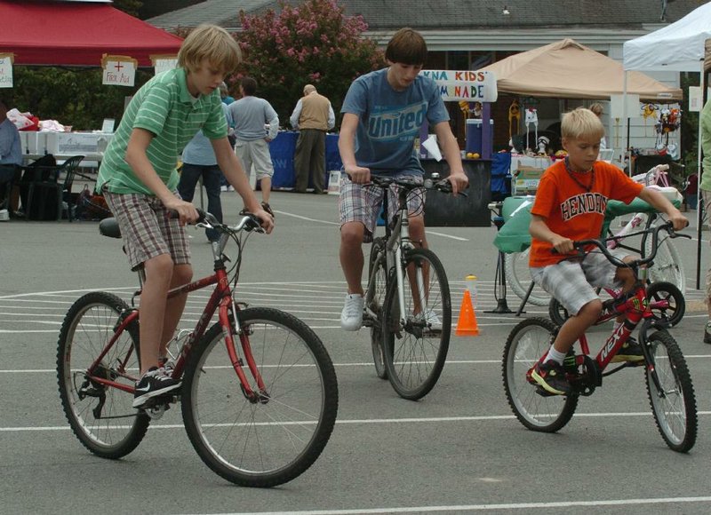 Riders (from left) Evan McRae, 14, Reece Mitchell, 13, and Case Gomlicker, 10, compete to see who can go the slowest during the “snail” race. The winner is the last to cross the finish line without losing his balance. 