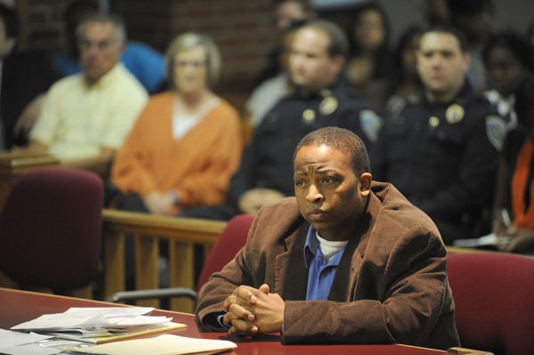 Hiram Graham listens Wednesday as his attorney speaks to potential jurors before his trial on attempted murder and second-degree battery of a police officer charges after a Fayetteville police officer was beaten while responding to a restaurant earlier this year.