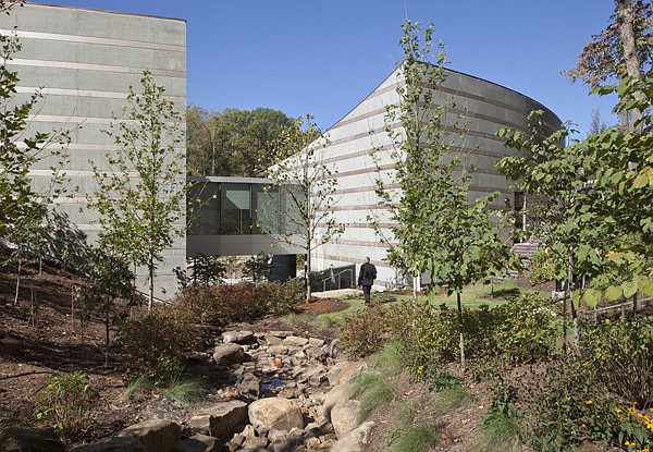 A man walks Thursday on a path at Crystal Bridges in Bentonville. Alice Walton chose Moshe Safdie to design the museum after visiting an earlier project of his, the Skirball Cultural Center in Los Angeles. “As you start moving through the museum, it’s constantly alternating between the art and the framing of nature for you,” Safdie said.
