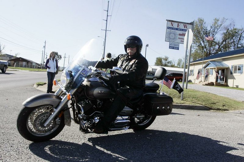 Arkansas Democrat-Gazette/WILLIAM MOORE
Vietnam Veteran and VFW Post 1674 member Ron Evans of Siloam Springs turns out from the post onto South Lincoln Street while participating in a fundraising motorcycle ride for Operation Renewal, an organization that provides support to military families dealing with deployment, Saturday, October 15, 2011 in Siloam Springs.