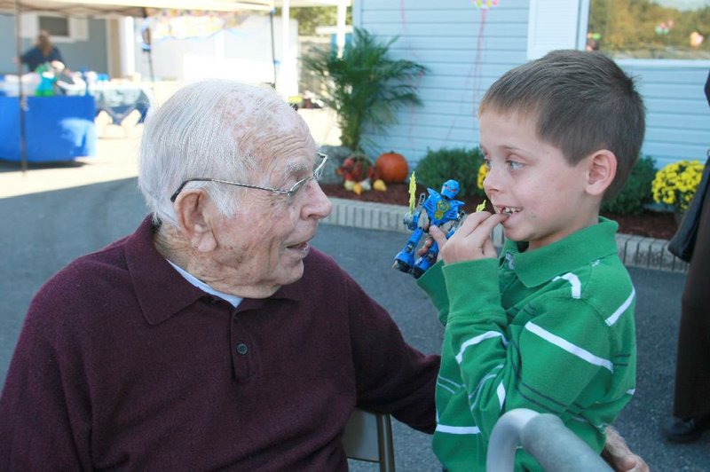Arkansas Democrat-Gazette/RICK MCFARLAND--10/15/11-- William F. Laman, former North Little Rock mayor, talks with Dillon Leicht, of Conway, his great grand nephew, about his missing front teeth at the 50th anniversary celebration for the North Little Rock Animal Shelter in Burns Park Saturday. He was mayor and instrumental in getting the shelter built 50 years ago.