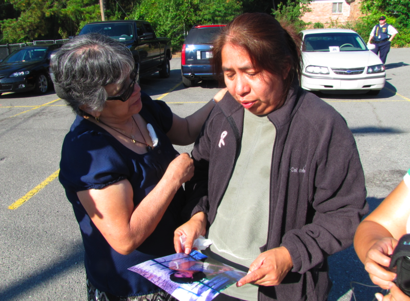 Family friend Isabel Zamora, left, comforts Lionor Garcia while Garcia looks at a photo of her daughter, Patricia Guardado on Monday morning.