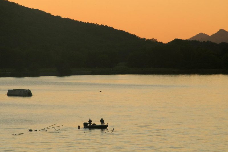 Fishermen cast into the waters of the Little Maumelle River on a recent Saturday evening, as seen from the midpoint of the Two Rivers Bridge. 