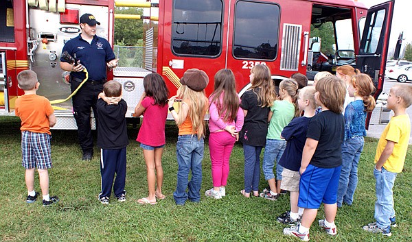 Fireman Matt Green explained the many knobs, dials and hoses on Gravette’s newly acquired pumper truck.
