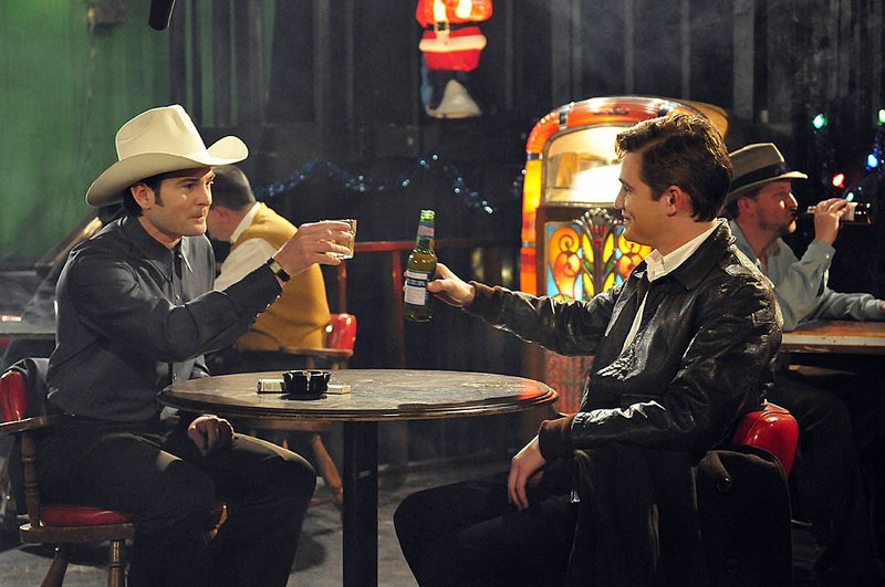 “Mr. Wells” (Henry Thomas) and his young chauffeur, Silas (Jesse James), share a drink in Harry Thomason’s The Last Ride. 