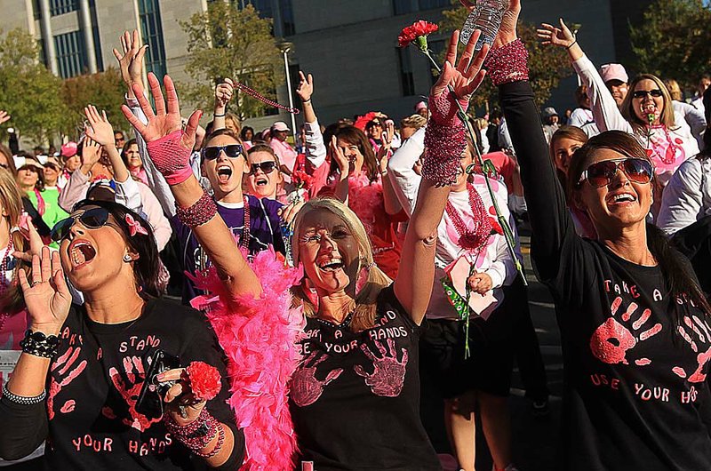 Susan G. Komen Race for the Cure participants cheer after finishing the race in downtown Little Rock. The board of the Arkansas Komen affiliate said that the decision to pull Planned Parenthood grants for breast screenings was made at Komen headquarters “without input from affiliates.” 