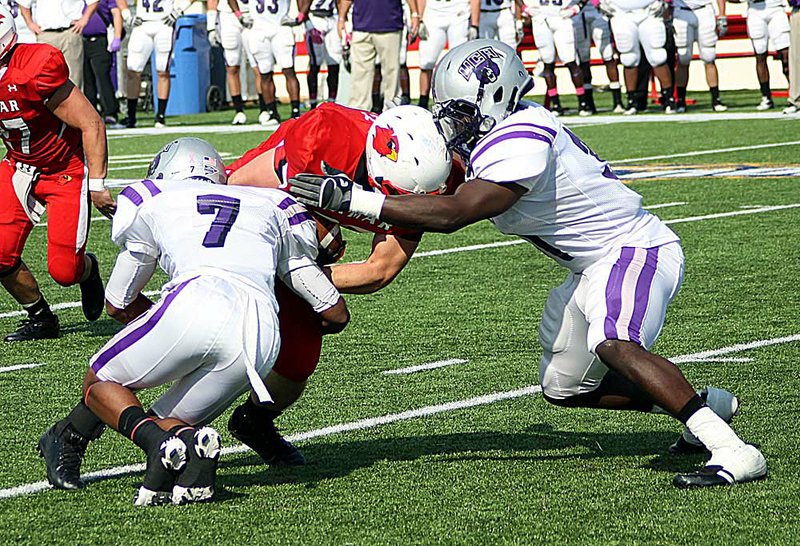  Central Arkansas defensive back Desmond Wilcox and linebacker Jessie Sims (right) take down Lamar tight end Payden McVey in the first half of Saturday’s game in Beaumont, Texas. 