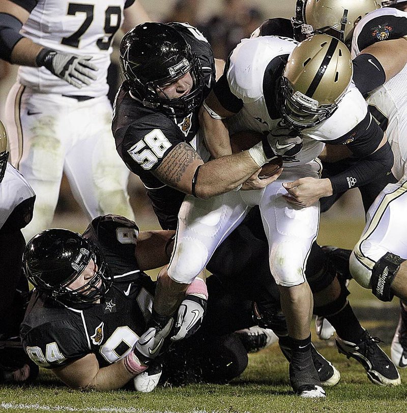  Vanderbilt defender Colt Nichter (58) brings down Army quarterback Trent Steelman during Saturday’s game. Vanderbilt rushed for 344 yards in its 44-21 victory. 