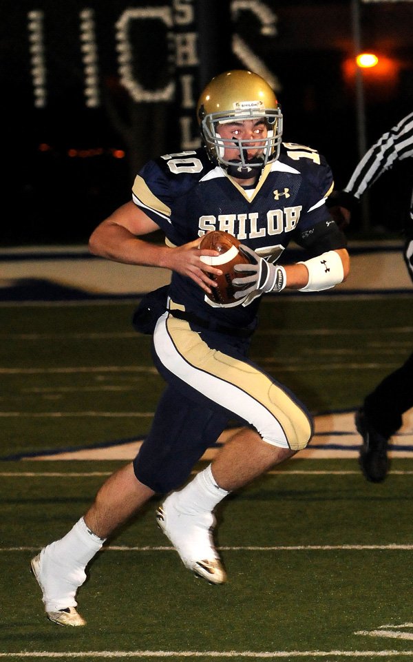 Drew Tyler, Shiloh Christian quarterback, runs to the outside Friday while looking for open receivers in the game against Gravette in Springdale.
