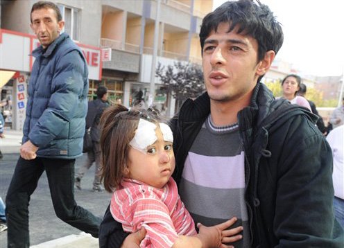 A man carries an injured child in the city of Van after a powerful earthquake struck eastern Turkey.  