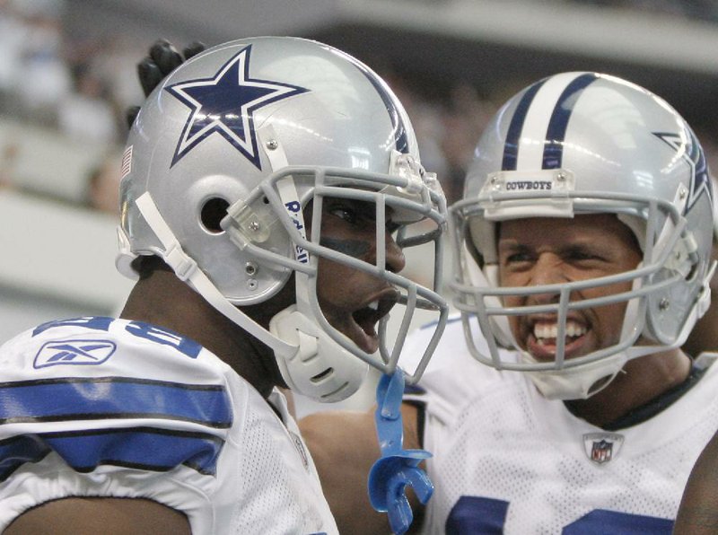 Dallas Cowboys running back DeMarco Murray (left) celebrates with teammate Miles Austin after Murray scored on a 91-yard run during the first half of Sunday’s game at Cowboys Stadium in Arlington, Texas. Murray’s 253 yards are a franchise record. 