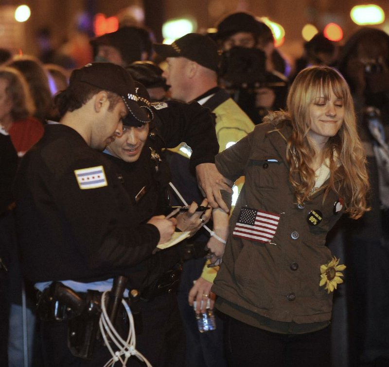 Police arrest a protester during an Occupy Chicago anti-Wall Street march in Grant Park on Sunday. 