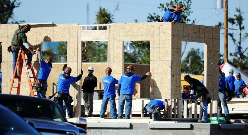 A construction team of volunteers for Extreme Makeover: Home Edition works on a new house for the Nguyen family of Joplin, Mo.

