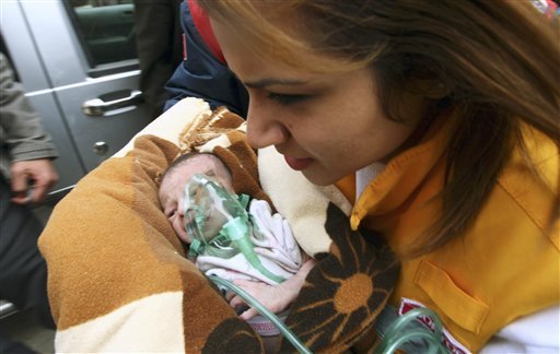 A Turkish medical doctor carries Azra Karaduman, a two-week-old baby girl saved by Turkish rescuers on Tuesday, Oct. 25, 2011.