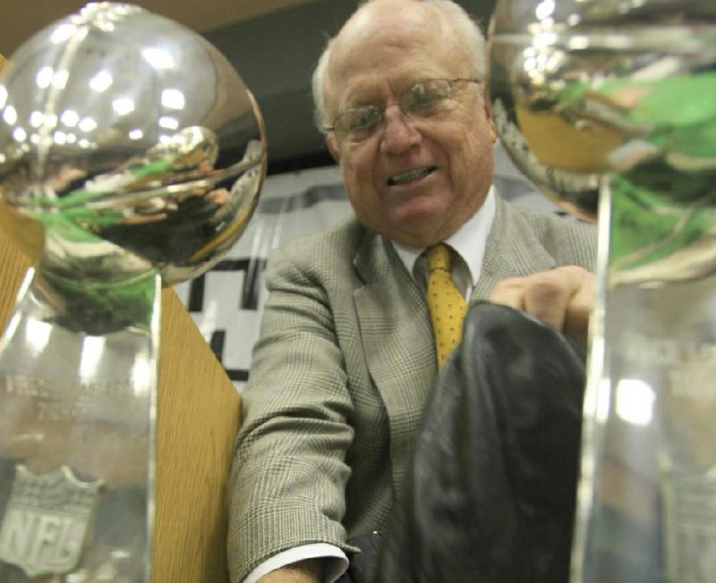 FILE — Former Dallas Cowboys director of scouting and Arkansas State coach Larry Lacewell unpacks his replica Super Bowl trophies and his championship rings Monday at the Little Rock Touchdown Club in this Oct. 24, 2011 file photo.