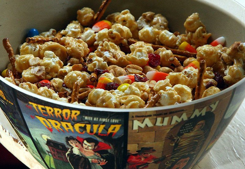 Extra or leftover Halloween candy can be transformed into a variety of desserts and snacks, such as this sweet and salty popcorn mix that includes pretzels, peanuts, chocolate candies, candy corn and caramel popcorn. 