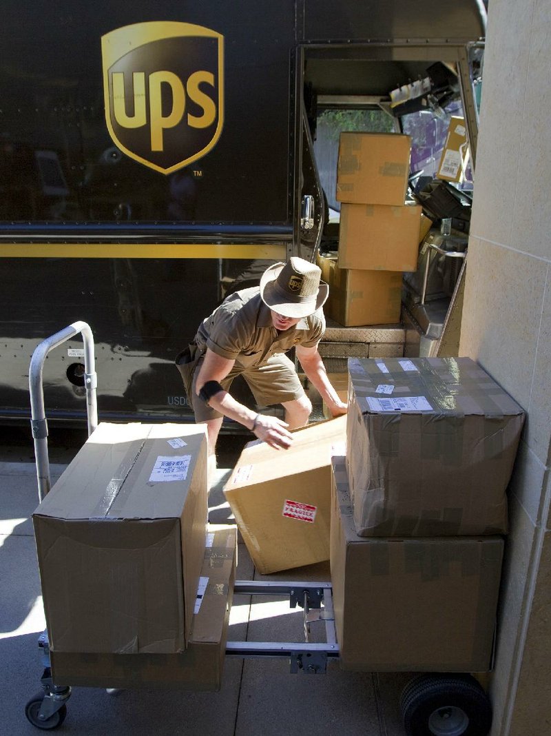 A UPS driver loads packages for delivery in Scottsdale, Ariz., earlier this month. UPS reported a falloff in shipments from China to the U.S. 