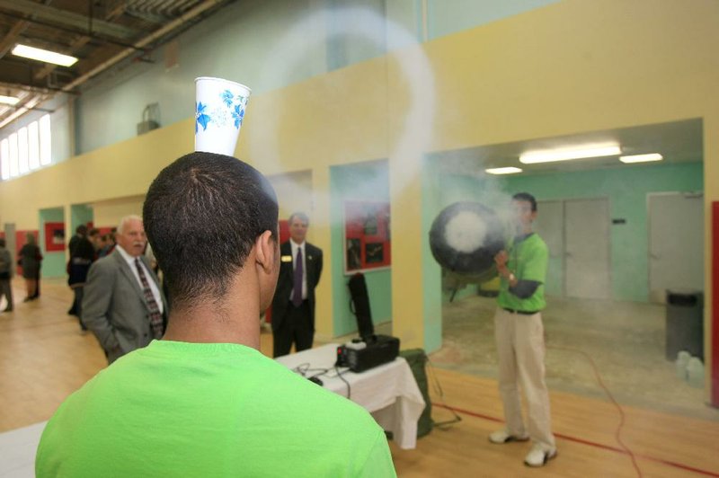 Tre Smiley, 16, (left) and Sakr Elsaidi, 17, use smoke to illustrate what a vortex is Tuesday at the new $6 million LISA Academy high school in Little Rock. 