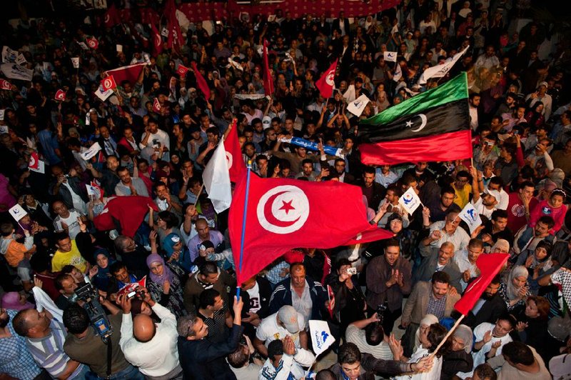 Supporters of the Ennahda Party celebrate Tuesday in Tunis, Tunisia, where early election results showed party gains. 