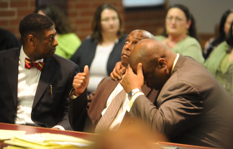 Raymond Robert Lee Douglas (left) and his attorney, Ronald Davis Jr., react Wednesday in Fayetteville to the jury’s acquittal of Douglas in the death of 65-year-old Goldie Thornsberry. 