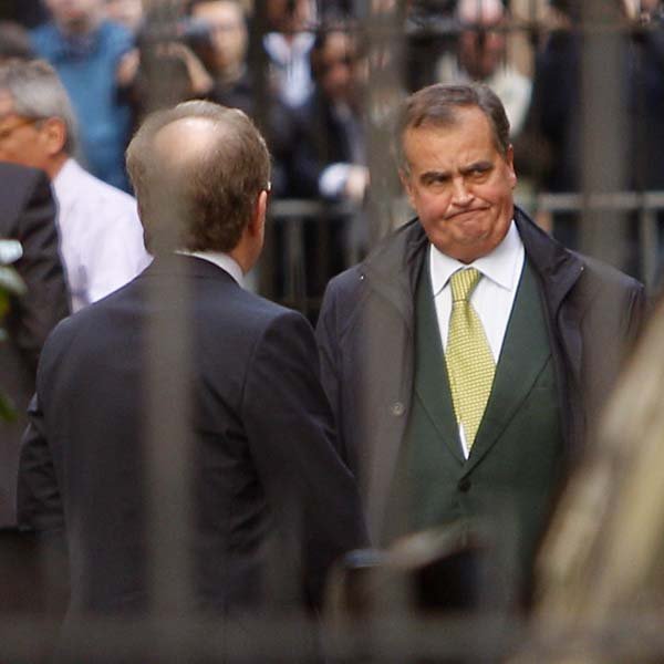 Roberto Calderoli (right) of Italy’s Northern League grimaces Tuesday after talks with Prime Minister Silvio Berlusconi about raising the retirement age. 