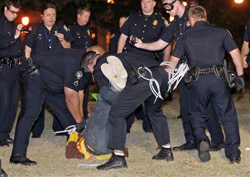 Police arrest one of dozens of Occupy Atlanta protesters in Woodruff Park early Wednesday morning, Oct. 26, 2011, in Atlanta. 