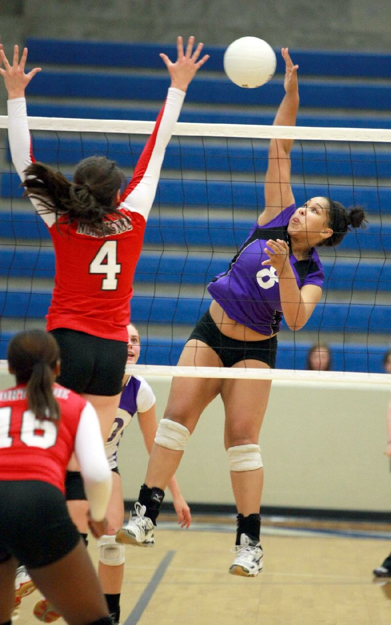 Fayetteville’s Mikayla Avery (8) hits the ball past Fort Smith Northside’s Kimmy Alexander (4) during the Lady Bulldogs’ 3-0 victory over the Lady Bears on Wednesday at the Class 7A volleyball state tournament in Conway. Avery had five service aces in the victory. 