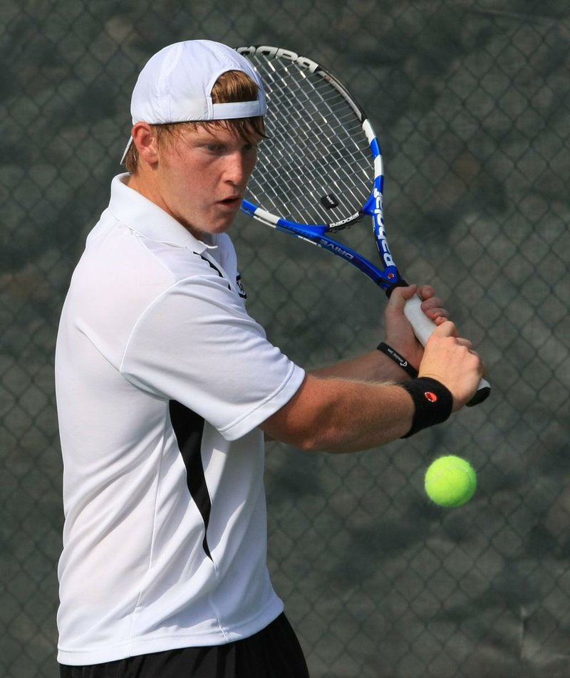 Austin Crawford of Little Rock Central hits a return shot to Conway Christian’s Drew Dodge during Crawford’s 6-0, 6-2 victory on Wednesday in the state overall high school tennis tournament at Burns Park in North Little Rock. 