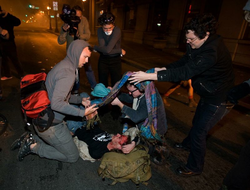 Occupy Wall Street protesters help Scott Olsen after he was struck by a police projectile while marching with other protesters Tuesday in Oakland, Calif. 