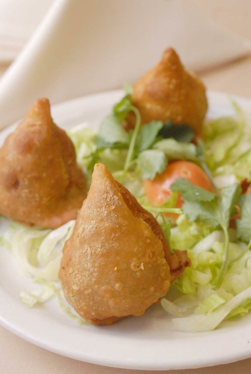 Vegetable Samosas, conical, crispfried patties stuffed with potatoes and green peas, top the appetizer menu at Amruth.