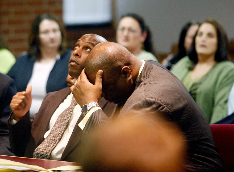 Raymond Robert Lee Douglas (left) and his attorney, Ronald Davis Jr., react Wednesday in Fayetteville to the jury’s acquittal of Douglas in the death of 65-year-old Goldie Thornsberry. 