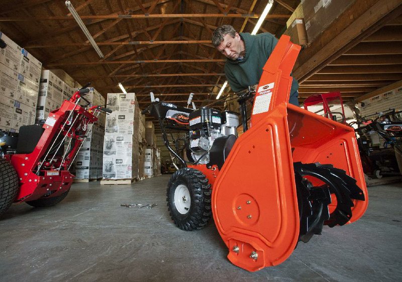 David Pfister assembles a new snowblower Tuesday at T&S Mower in Olmsted Falls, Ohio. Orders for heavy machinery and other long-lasting manufactured goods were up in September, the Commerce Department said Wednesday. 